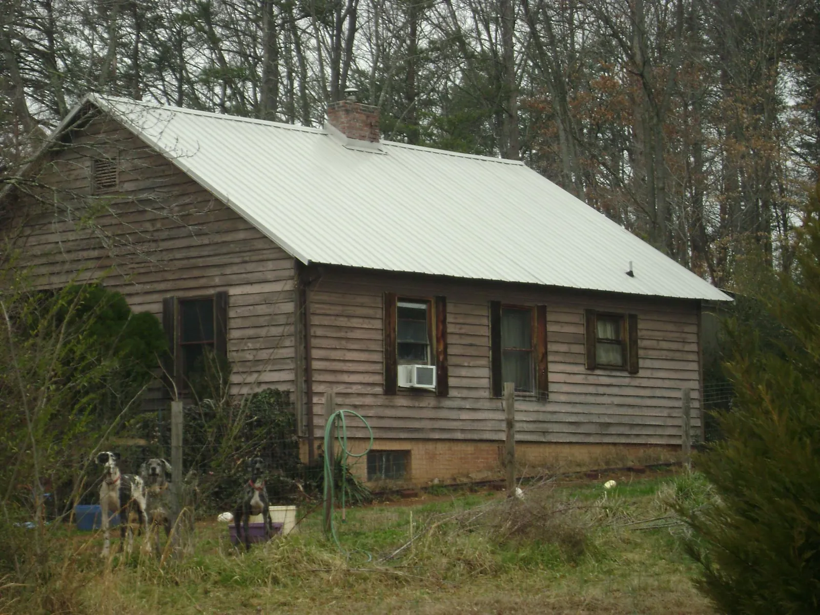 White metal roof on an old wood sided farmhouse, from a Metal Roof Installation job in Harbor View